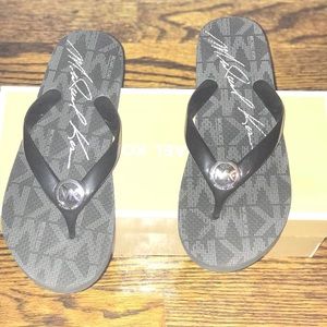 Black and silver Michael Kors flip flops